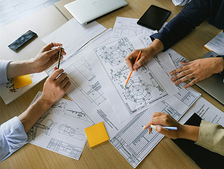 people working over plans